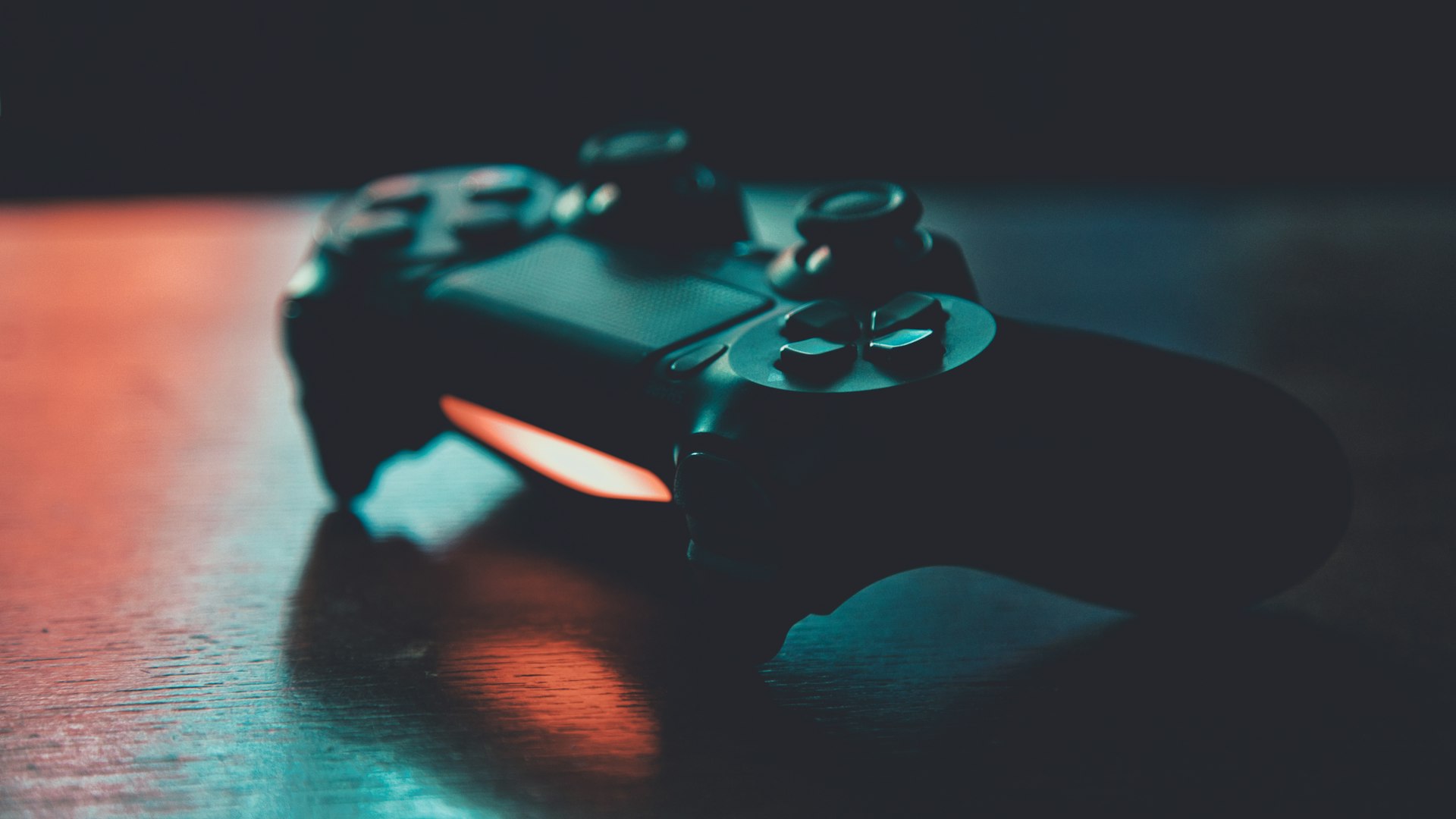 Neon-lit gaming lounge with rows of gaming stations